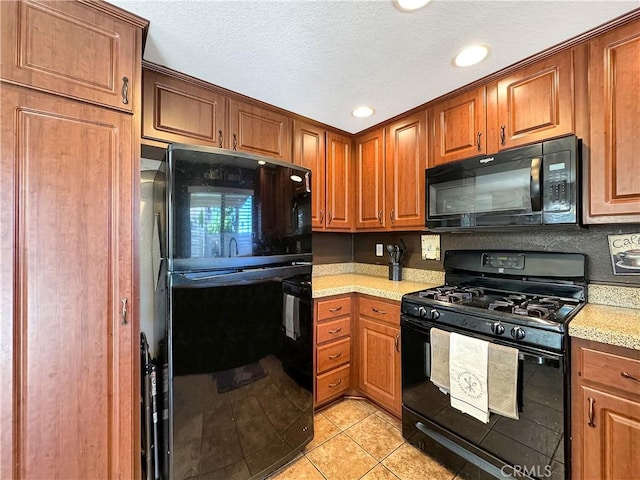 11700 White Pine Ct, Fontana, CA 92337 - kitchen with black appliances, light tile patterned floors, brown cabinetry, recessed lighting, and a textured ceiling