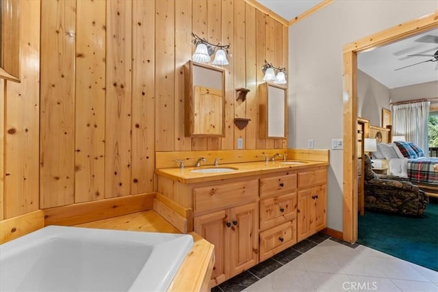 25148 Scenic View Dr, Crestline, CA 92325 - ensuite bathroom with tile patterned flooring, double vanity, a ceiling fan, wood walls, and a tub to relax in