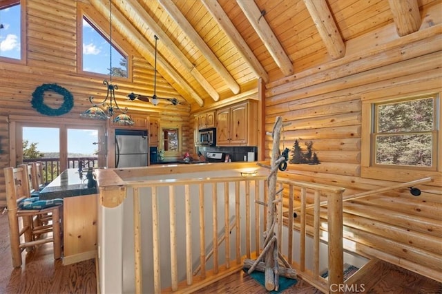25148 Scenic View Dr, Crestline, CA 92325 - kitchen featuring appliances with stainless steel finishes, plenty of natural light, a wood ceiling with exposed beams, wood finished floors, and log walls