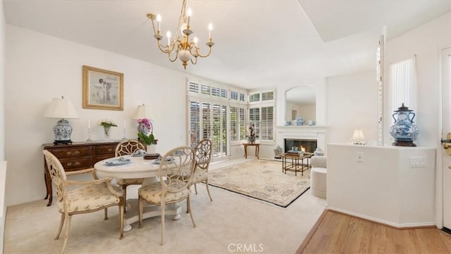 3620 Daffodil Ave Unit 31, Corona Del Mar, CA 92625 - dining space featuring a chandelier, wood finished floors, and a fireplace