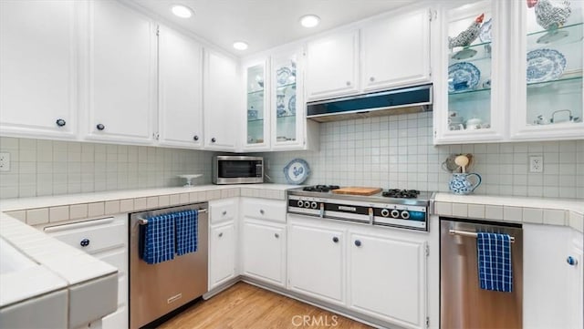 3620 Daffodil Ave Unit 31, Corona Del Mar, CA 92625 - kitchen featuring stainless steel appliances, tile counters, white cabinets, and recessed lighting