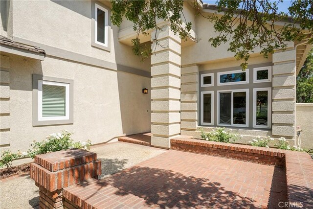 9320 Isaac Lord Dr, Rancho Cucamonga, CA 91701 - doorway to property featuring stucco siding and a patio