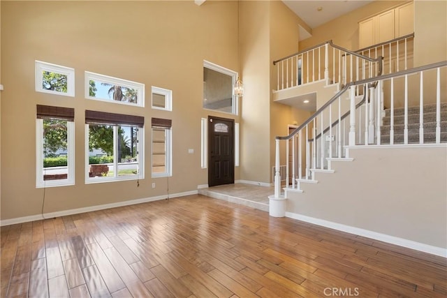 9320 Isaac Lord Dr, Rancho Cucamonga, CA 91701 - foyer entrance with a towering ceiling, hardwood / wood-style floors, and stairway