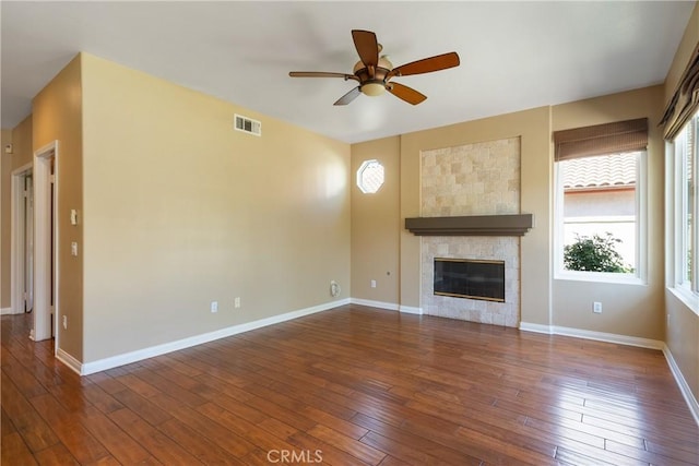 9320 Isaac Lord Dr, Rancho Cucamonga, CA 91701 - unfurnished living room featuring ceiling fan, hardwood / wood-style flooring, and a tiled fireplace