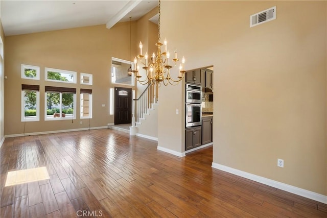 9320 Isaac Lord Dr, Rancho Cucamonga, CA 91701 - unfurnished living room featuring high vaulted ceiling, hardwood / wood-style floors, and a chandelier