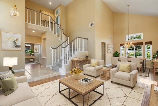9320 Isaac Lord Dr, Rancho Cucamonga, CA 91701 - living room with a chandelier, wood finished floors, high vaulted ceiling, and stairs