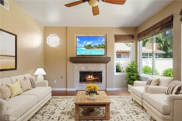 9320 Isaac Lord Dr, Rancho Cucamonga, CA 91701 - living room with light wood-type flooring, a ceiling fan, and a fireplace