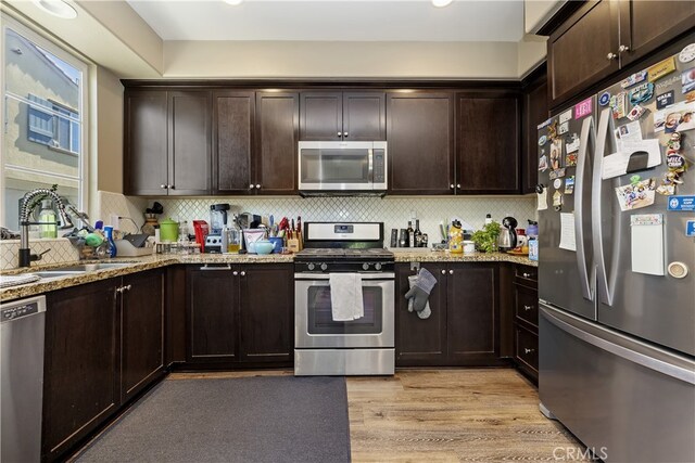 384 Ruby Red Ln, Upland, CA 91786 - kitchen with appliances with stainless steel finishes, dark brown cabinets, decorative backsplash, and recessed lighting