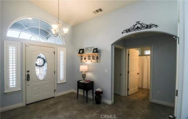 18224 Kalin Ranch Dr, Victorville, CA 92395 - entrance foyer featuring arched walkways, a chandelier, healthy amount of natural light, and vaulted ceiling
