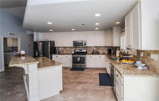 18224 Kalin Ranch Dr, Victorville, CA 92395 - kitchen featuring stainless steel appliances, white cabinets, decorative backsplash, and recessed lighting