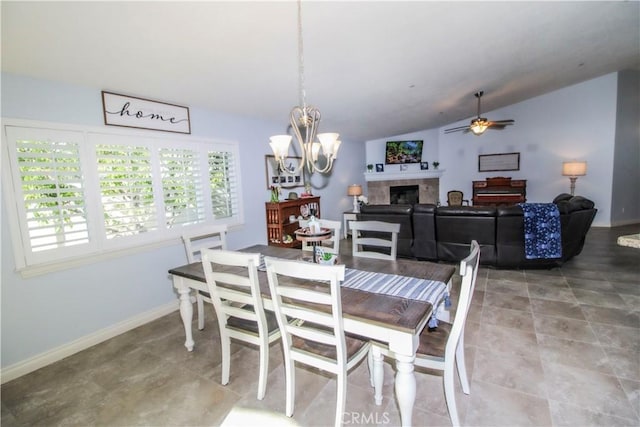 18224 Kalin Ranch Dr, Victorville, CA 92395 - dining space featuring lofted ceiling, a tiled fireplace, a ceiling fan, and a chandelier