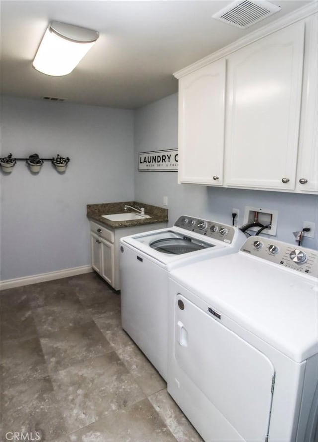 18224 Kalin Ranch Dr, Victorville, CA 92395 - washroom featuring cabinet space, washer and dryer, and stone finish flooring