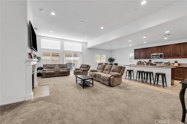 16252 Gibson St, Victorville, CA 92394 - living room with light colored carpet, recessed lighting, and a fireplace