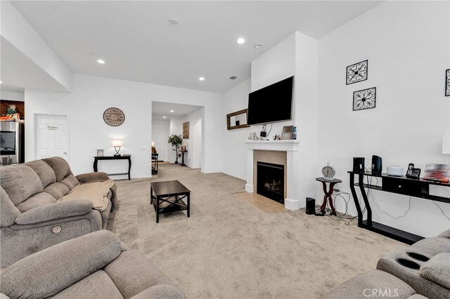 16252 Gibson St, Victorville, CA 92394 - living room with light carpet, recessed lighting, and a tiled fireplace