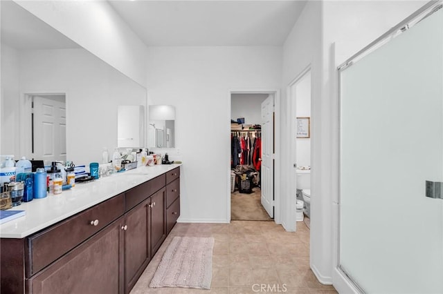 16252 Gibson St, Victorville, CA 92394 - bathroom with vanity, a stall shower, and a walk in closet