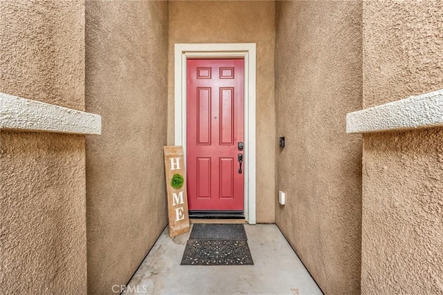 16252 Gibson St, Victorville, CA 92394 - doorway to property featuring stucco siding