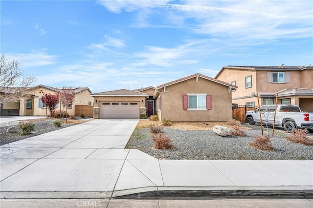 16252 Gibson St, Victorville, CA 92394 - view of front of property with stucco siding, driveway, and an attached garage
