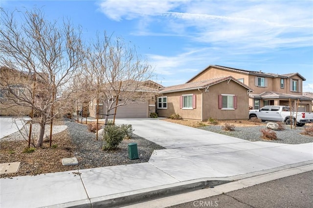 16252 Gibson St, Victorville, CA 92394 - ranch-style home featuring concrete driveway, stucco siding, and an attached garage