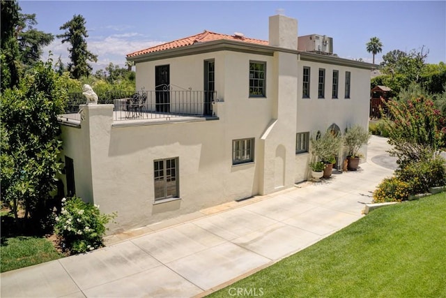 1205 W Highland, Redlands, CA 92373 - view of front of home featuring stucco siding, a chimney, a patio area, and a tile roof