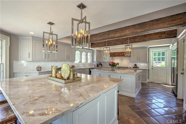 1205 W Highland, Redlands, CA 92373 - kitchen with a large island, tasteful backsplash, a chandelier, and light stone counters