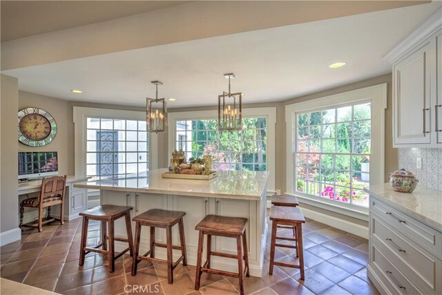 1205 W Highland, Redlands, CA 92373 - kitchen with white cabinets, a kitchen bar, recessed lighting, a center island, and a chandelier