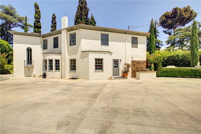 1205 W Highland, Redlands, CA 92373 - view of front facade with stucco siding, a chimney, and a patio area