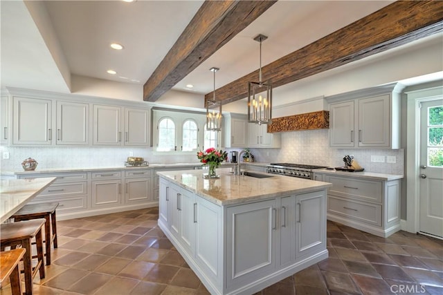 1205 W Highland, Redlands, CA 92373 - kitchen with backsplash, a chandelier, recessed lighting, a kitchen island with sink, and pendant lighting
