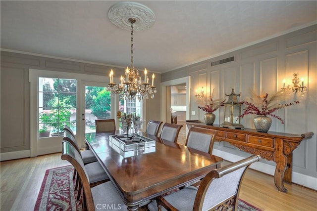 1205 W Highland, Redlands, CA 92373 - dining room featuring a decorative wall, a chandelier, light wood-style flooring, and crown molding