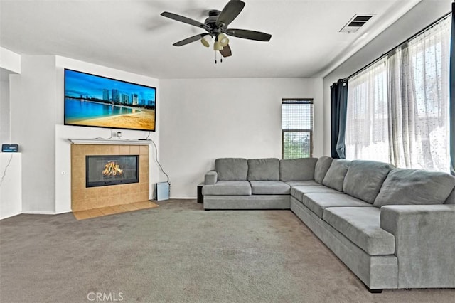 629 Ivy Crest Dr, San Jacinto, CA 92582 - living room with carpet flooring, a tile fireplace, and ceiling fan