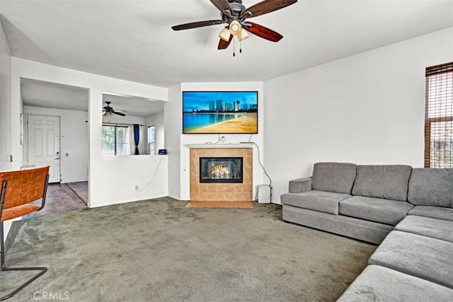 629 Ivy Crest Dr, San Jacinto, CA 92582 - living room featuring a ceiling fan, a tile fireplace, and carpet