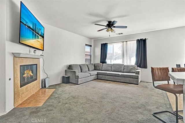 629 Ivy Crest Dr, San Jacinto, CA 92582 - living area featuring carpet floors, a fireplace, and a ceiling fan