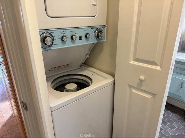 1540 Northwood Rd Unit 11-270L, Seal Beach, CA 90740 - washroom featuring stacked washer / drying machine and dark tile patterned flooring
