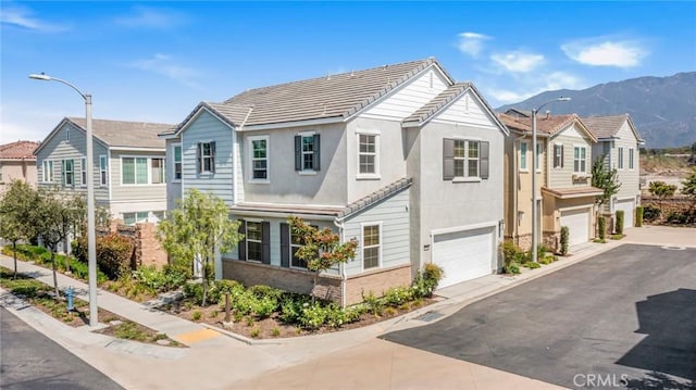 1633 Topeka Pl, Upland, CA 91784 - townhome / multi-family property with an attached garage, a mountain view, asphalt driveway, and a tiled roof