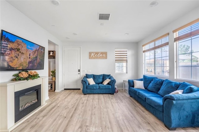 1633 Topeka Pl, Upland, CA 91784 - living room with light wood-style flooring and a glass covered fireplace