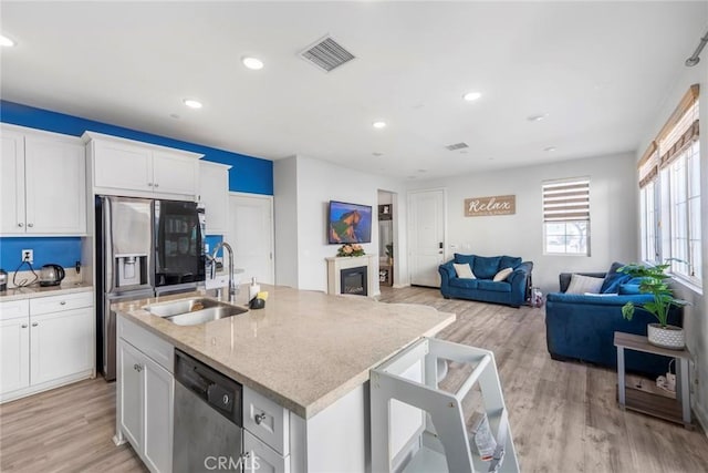 1633 Topeka Pl, Upland, CA 91784 - kitchen with stainless steel appliances, open floor plan, light wood finished floors, an island with sink, and recessed lighting