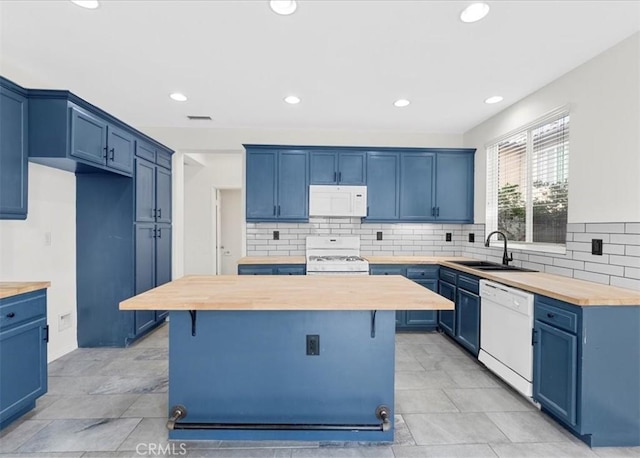 13837 Emerald Ln, Gardena, CA 90247 - kitchen with wooden counters, white appliances, blue cabinetry, decorative backsplash, and a kitchen island