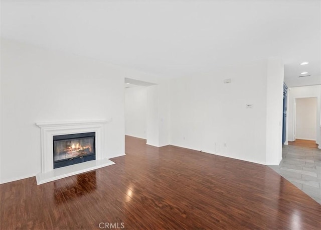 13837 Emerald Ln, Gardena, CA 90247 - unfurnished living room with wood finished floors, a glass covered fireplace, and recessed lighting