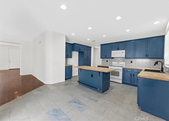 13837 Emerald Ln, Gardena, CA 90247 - kitchen with white appliances, wood counters, blue cabinetry, a kitchen island, and tasteful backsplash