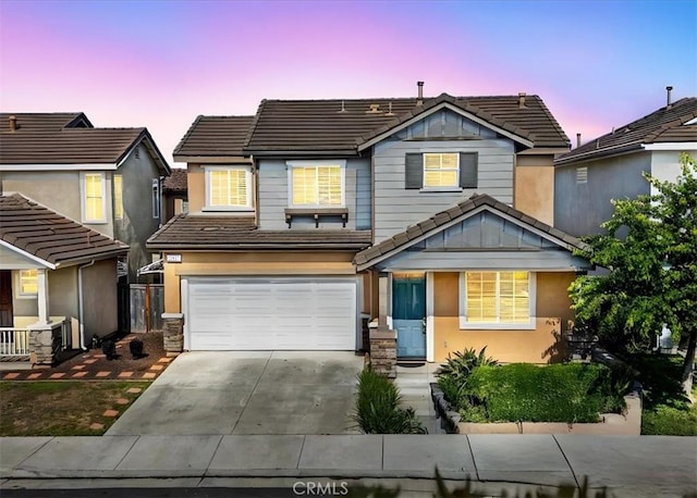 13837 Emerald Ln, Gardena, CA 90247 - view of front of home featuring a tiled roof, driveway, a garage, and stucco siding