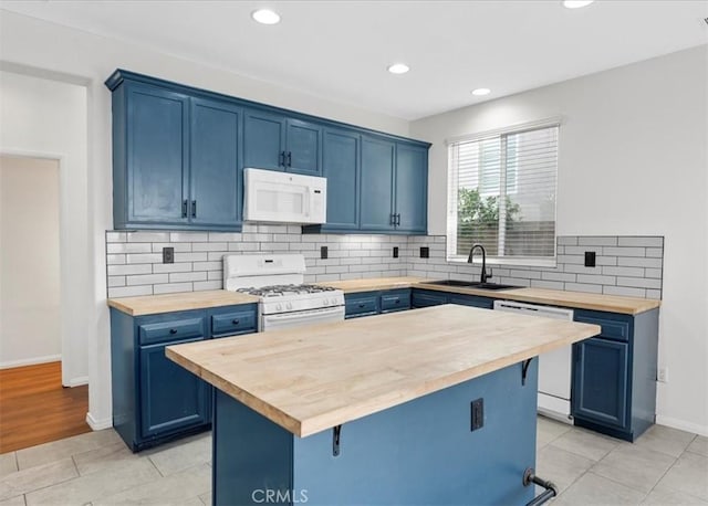 13837 Emerald Ln, Gardena, CA 90247 - kitchen with butcher block countertops, white appliances, blue cabinetry, and recessed lighting