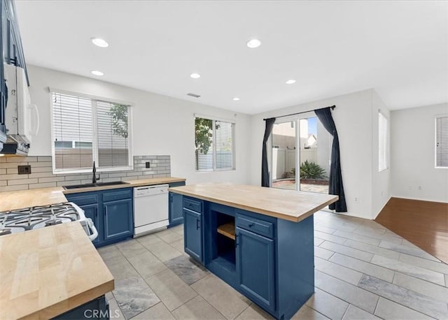 13837 Emerald Ln, Gardena, CA 90247 - kitchen featuring dishwasher, butcher block counters, blue cabinets, backsplash, and recessed lighting