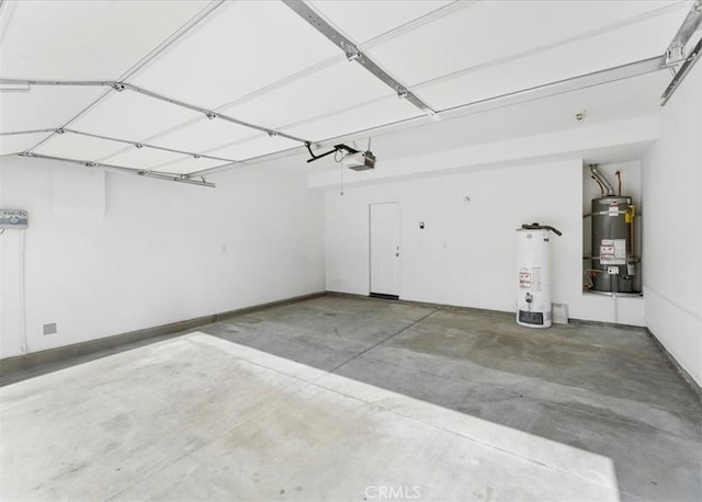 13837 Emerald Ln, Gardena, CA 90247 - garage featuring secured water heater, water heater, and a garage door opener