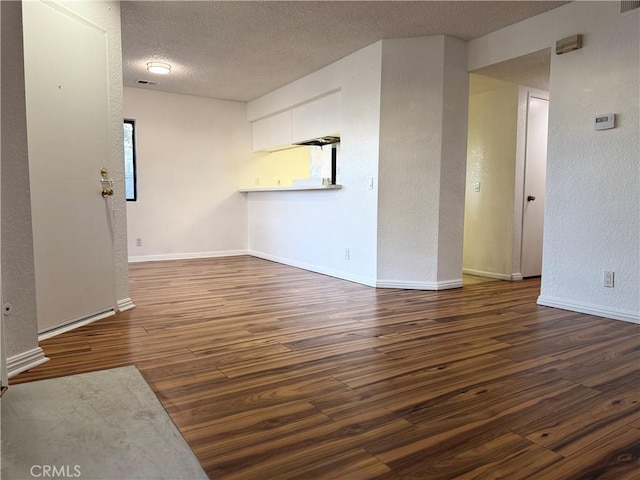 102 Park Shadow Ct, Baldwin Park, CA 91706 - unfurnished living room featuring wood finished floors, a textured ceiling, and a textured wall