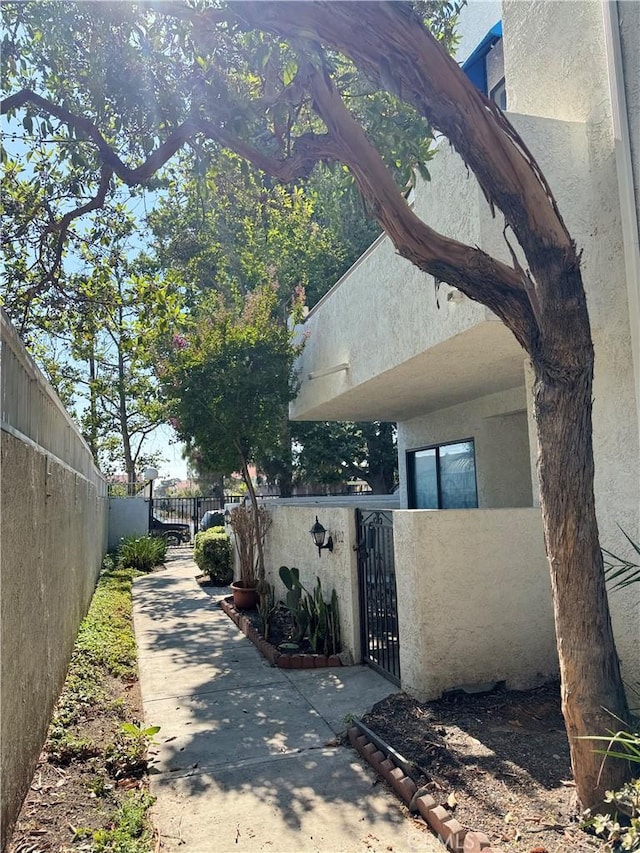 102 Park Shadow Ct, Baldwin Park, CA 91706 - view of property exterior with stucco siding and a gate