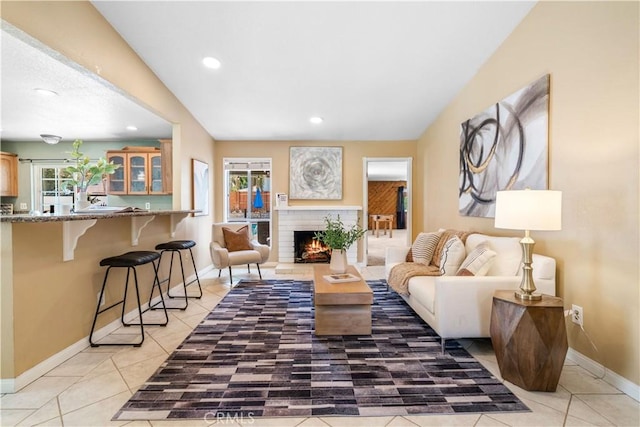 6910 Valinda Ave, Rancho Cucamonga, CA 91701 - living room featuring light tile patterned flooring, recessed lighting, and a fireplace