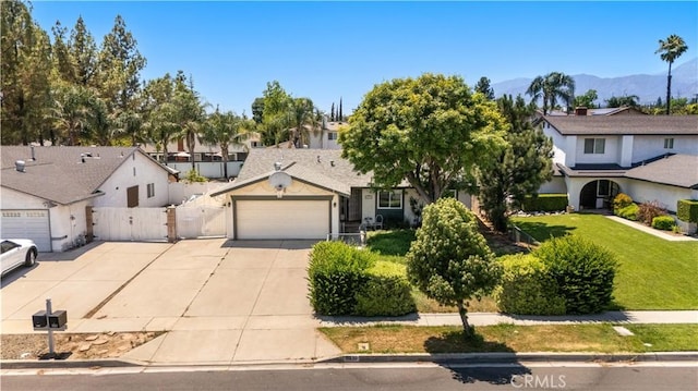 6910 Valinda Ave, Rancho Cucamonga, CA 91701 - view of front facade with a garage, concrete driveway, a gate, a mountain view, and a residential view