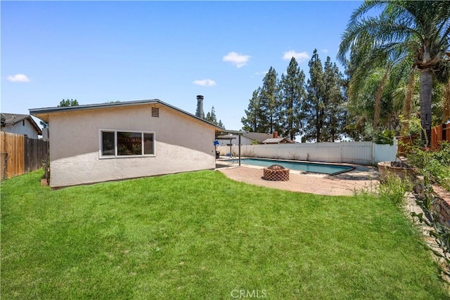 6910 Valinda Ave, Rancho Cucamonga, CA 91701 - back of house with stucco siding, a fenced backyard, a patio, and a fire pit