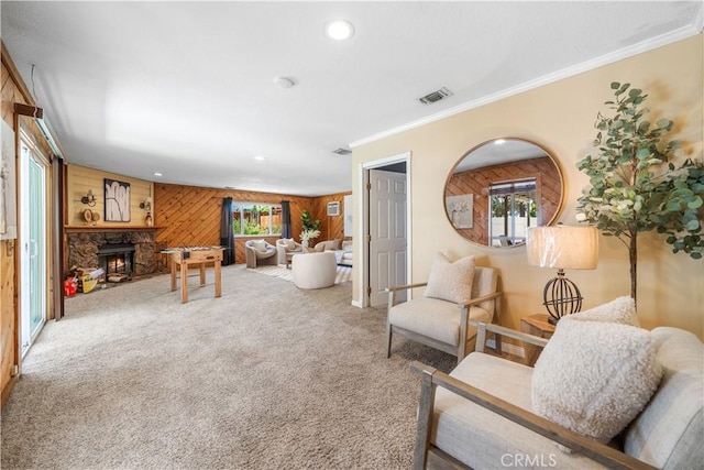 6910 Valinda Ave, Rancho Cucamonga, CA 91701 - carpeted living room featuring wood walls, ornamental molding, recessed lighting, and a stone fireplace