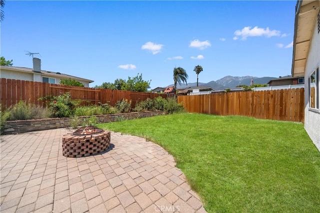 6910 Valinda Ave, Rancho Cucamonga, CA 91701 - fenced backyard with an outdoor fire pit, a patio, and a mountain view