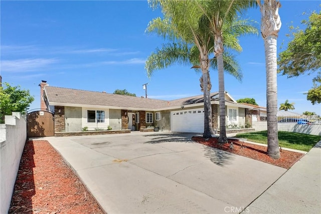 2622 S Pacific Ave, Santa Ana, CA 92704 - ranch-style home with stucco siding, concrete driveway, an attached garage, and a gate
